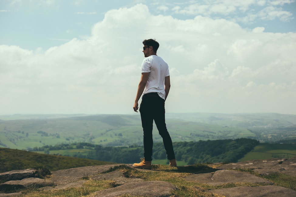 man looking over cliff